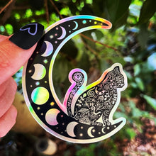 Load image into Gallery viewer, Cat Sitting on Moon Holographic Sticker. Sun And Moon Sticker. Witchy Sticker. Black Cat. Cat Sticker. High quality Trippy Sticker