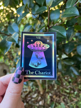 Load image into Gallery viewer, The Chariot Tarot Card Holographic Sticker. Dinosaur Alien Abduction Sticker. UFO Stickers. Dinosaurs. High quality Stickers.