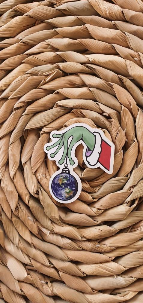 Christmas Ball Sticker. Alien Hand Holding Earth. Christmas Ornaments. Christmas Decorations. Trippy Xmas Sticker.